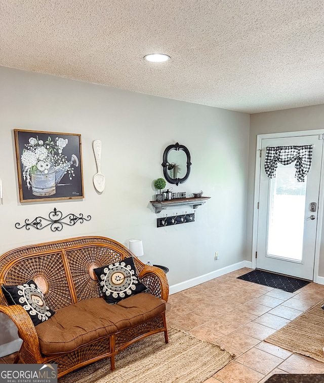 tiled foyer with a textured ceiling