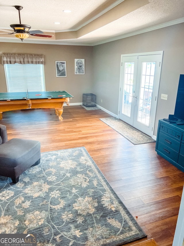 game room featuring french doors, a textured ceiling, hardwood / wood-style flooring, and ceiling fan