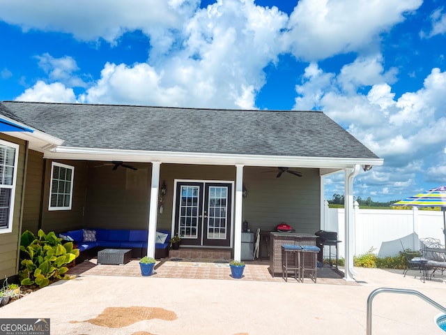 rear view of property with an outdoor living space, a patio, and ceiling fan