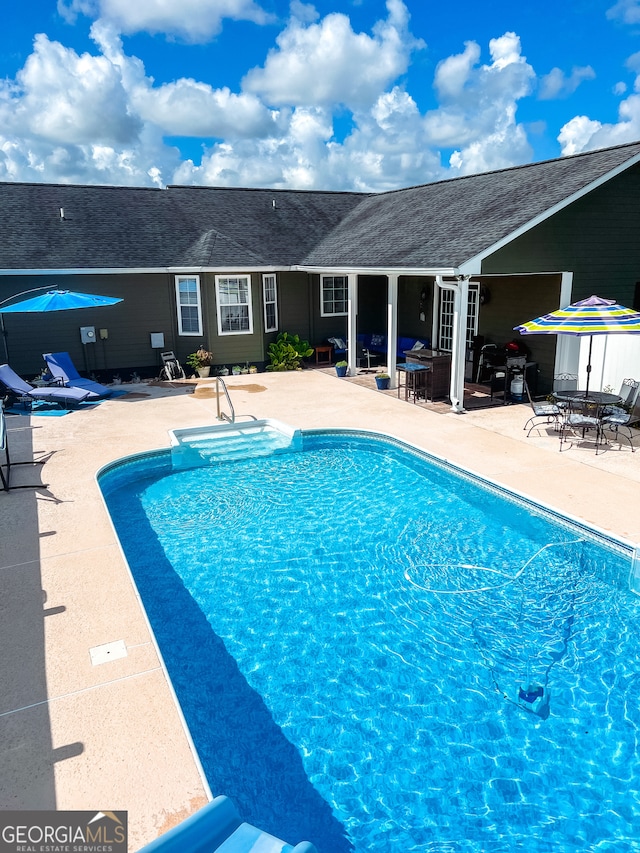 view of swimming pool featuring a patio area