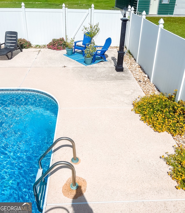 view of swimming pool with a patio area