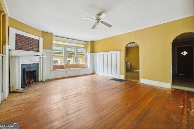 unfurnished living room with ceiling fan, hardwood / wood-style floors, and crown molding