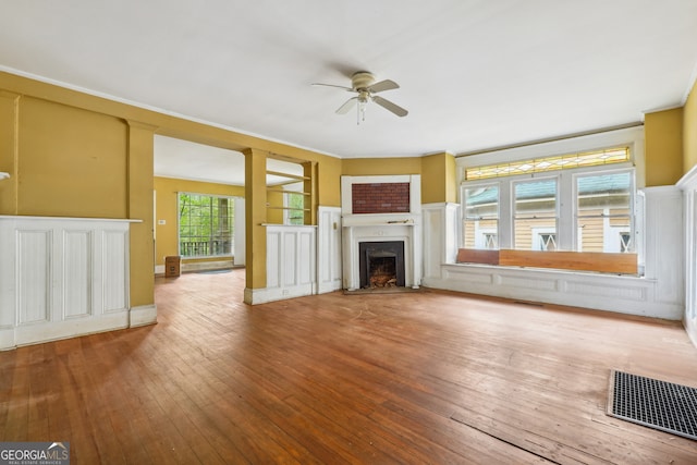 unfurnished living room featuring hardwood / wood-style floors and ceiling fan