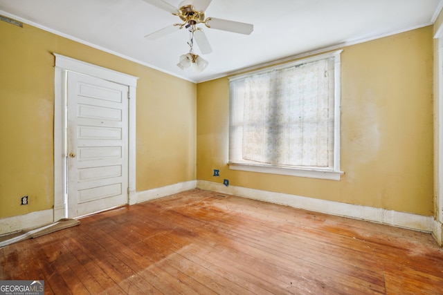 unfurnished room featuring ceiling fan, wood-type flooring, and ornamental molding