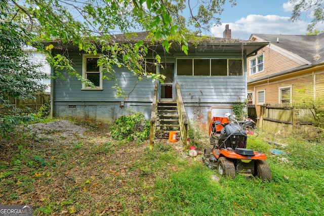 back of house with a sunroom