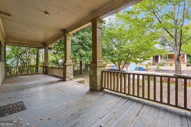 wooden terrace featuring covered porch