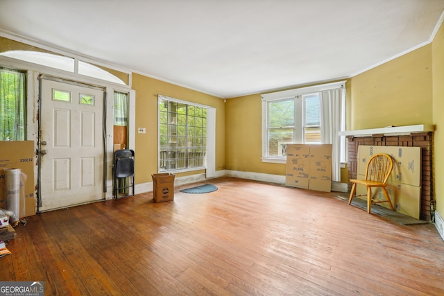 foyer entrance with hardwood / wood-style floors and ornamental molding