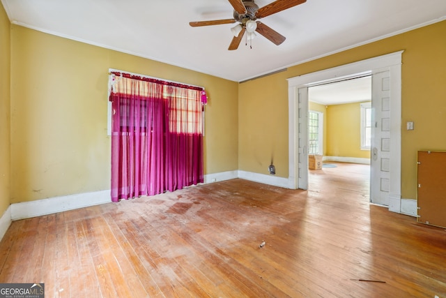 unfurnished room with hardwood / wood-style flooring, ceiling fan, and crown molding