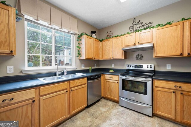 kitchen featuring a textured ceiling, sink, and appliances with stainless steel finishes