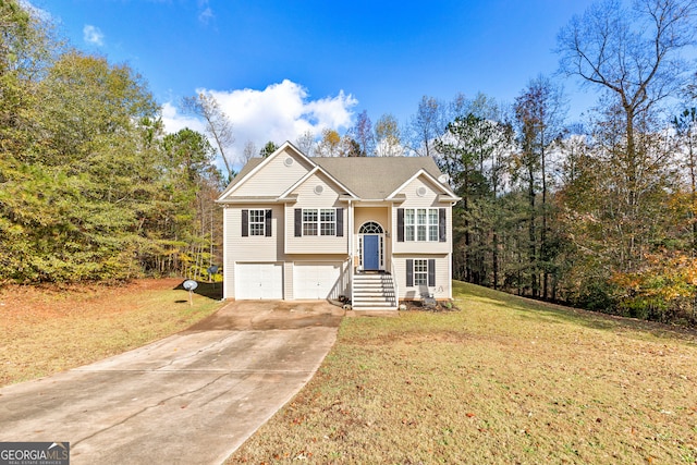 raised ranch with a garage and a front lawn