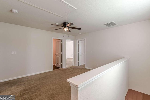 hallway featuring carpet floors and a textured ceiling