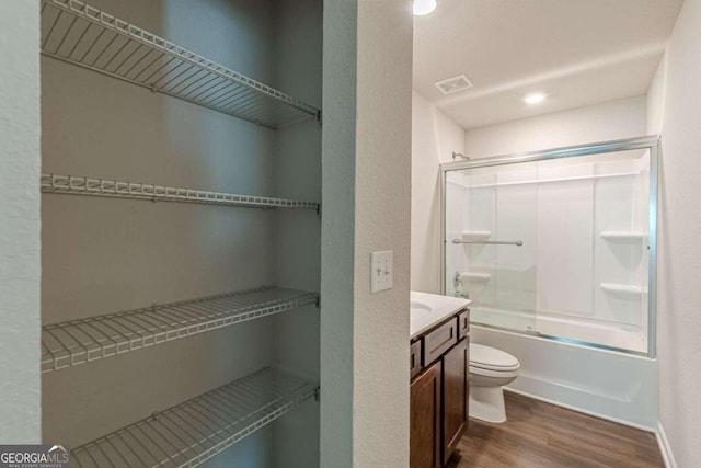 full bathroom with toilet, vanity, enclosed tub / shower combo, and hardwood / wood-style flooring