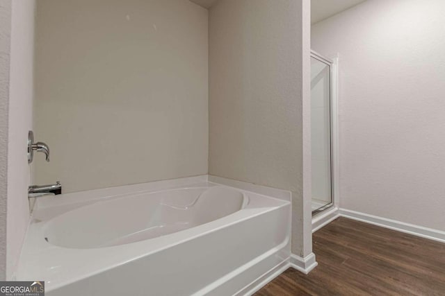 bathroom featuring separate shower and tub and hardwood / wood-style floors