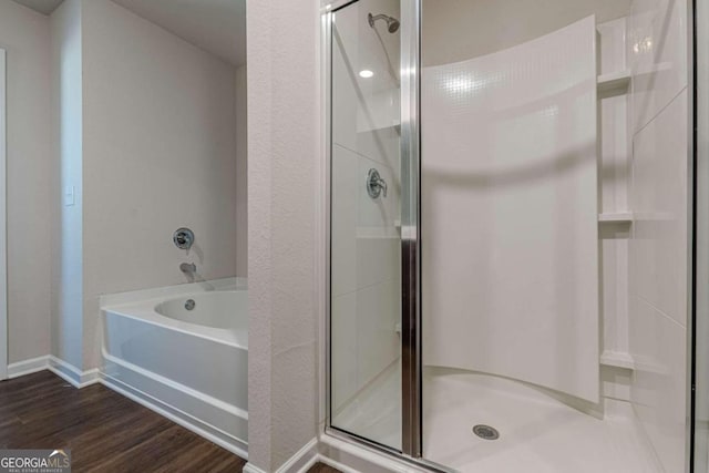 bathroom featuring separate shower and tub and hardwood / wood-style floors