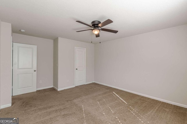 unfurnished bedroom with ceiling fan and carpet