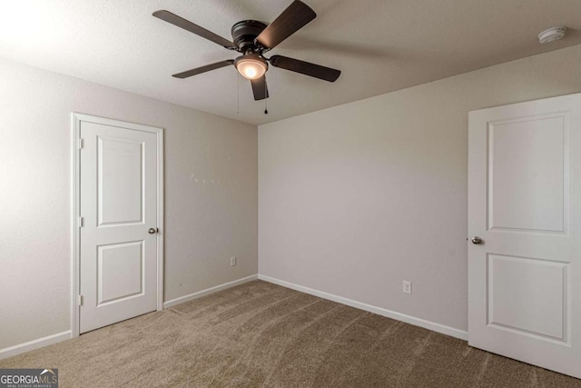 unfurnished room featuring carpet and ceiling fan