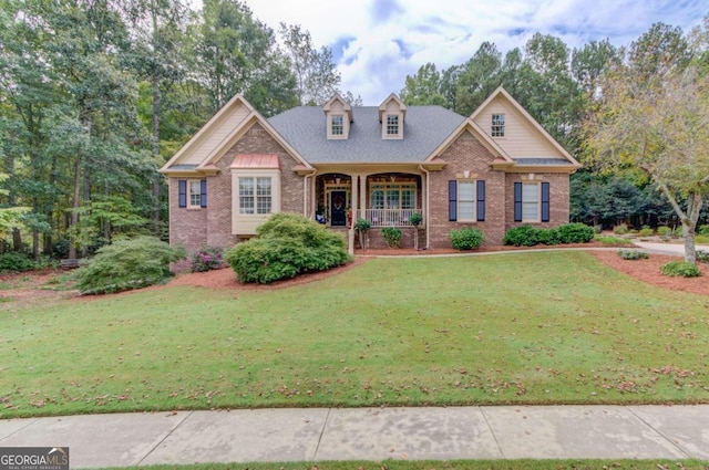 craftsman inspired home featuring a porch and a front lawn