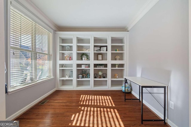 unfurnished room with ornamental molding and dark wood-type flooring