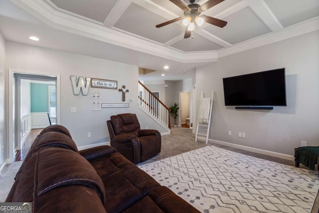 living room with ceiling fan, carpet floors, coffered ceiling, and ornamental molding