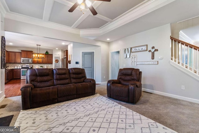 carpeted living room with beamed ceiling, ceiling fan with notable chandelier, and ornamental molding