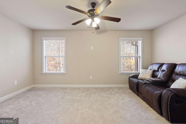 carpeted living room with ceiling fan