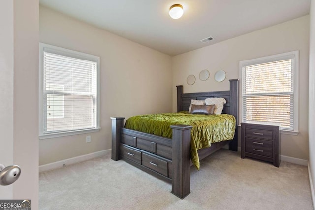 bedroom featuring light carpet