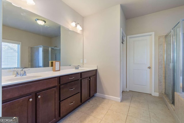 bathroom with tile patterned floors, vanity, and a shower with shower door