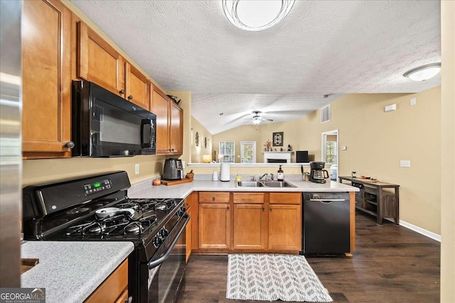 kitchen with sink, dark hardwood / wood-style floors, vaulted ceiling, and black appliances