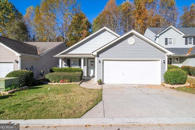 view of front of property featuring a front lawn and a garage