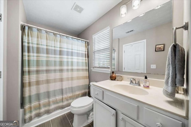 bathroom featuring tile patterned flooring, vanity, and toilet