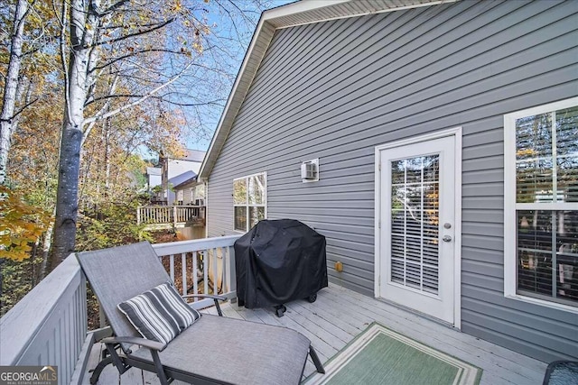 wooden terrace featuring a grill