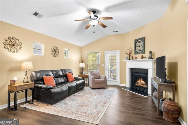 living room featuring dark hardwood / wood-style floors, ceiling fan, and lofted ceiling