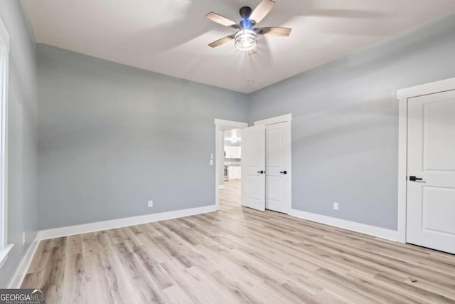 unfurnished bedroom with light hardwood / wood-style floors and ceiling fan