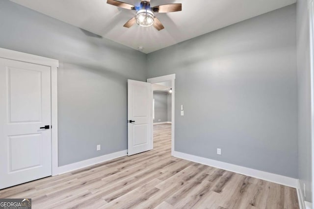 spare room featuring ceiling fan and light hardwood / wood-style flooring