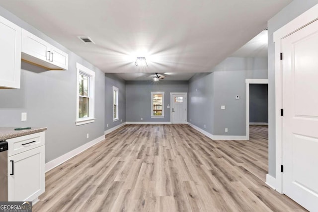 unfurnished living room with light wood-type flooring and ceiling fan