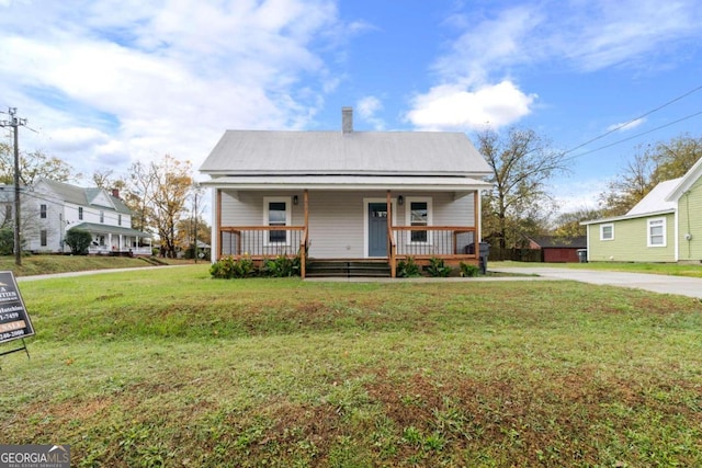 bungalow-style home with a porch and a front lawn