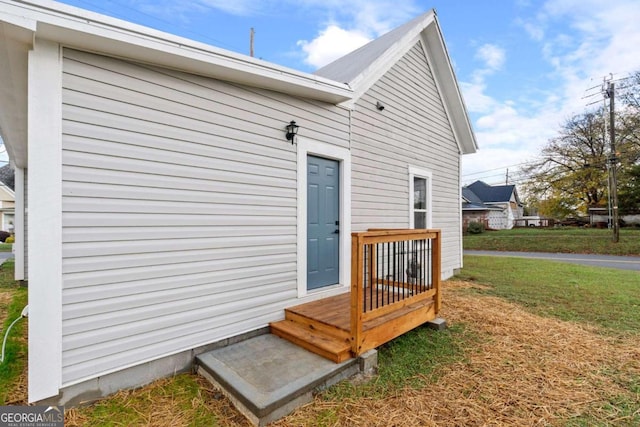 property entrance with a lawn