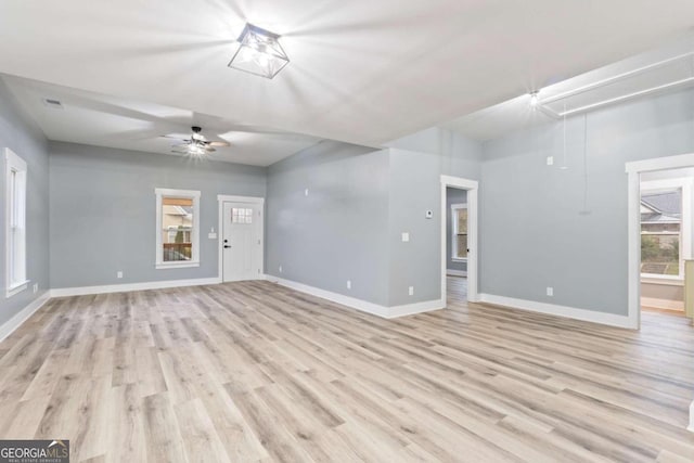 unfurnished living room featuring ceiling fan and light wood-type flooring