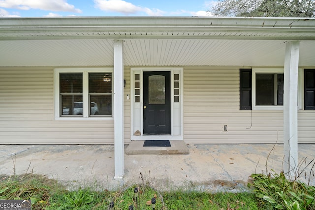 view of exterior entry with a porch