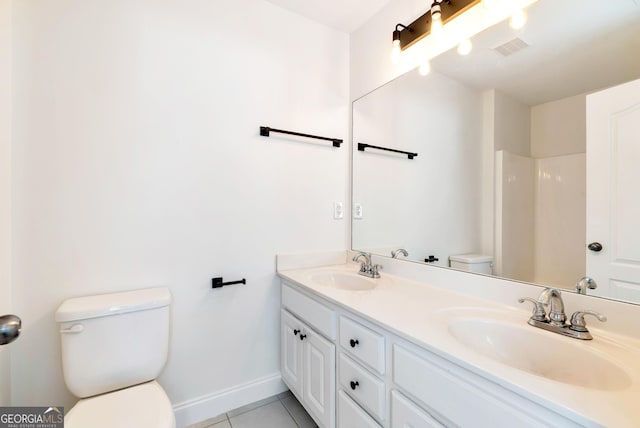 bathroom featuring toilet, vanity, and tile patterned floors