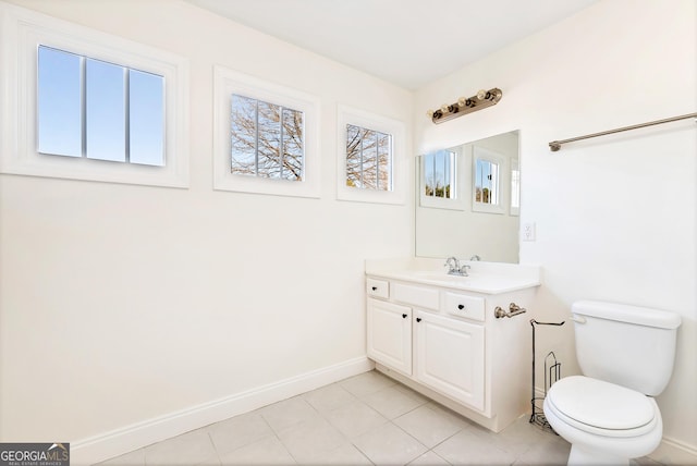 bathroom with tile patterned flooring, vanity, and toilet