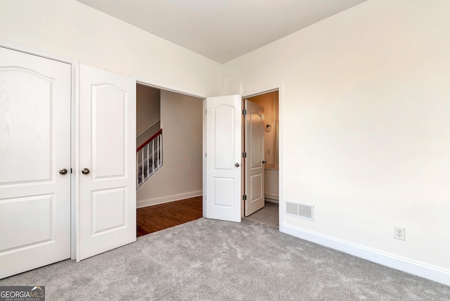 unfurnished bedroom with light colored carpet