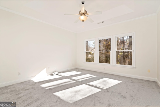 empty room with carpet floors, ceiling fan, and ornamental molding