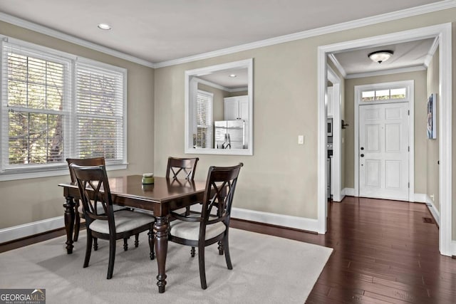 dining room featuring dark wood-type flooring and ornamental molding