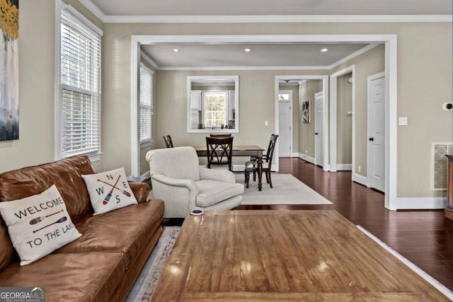 living room with crown molding, dark wood-type flooring, and a healthy amount of sunlight