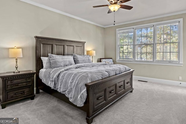 bedroom with light carpet, ceiling fan, and crown molding