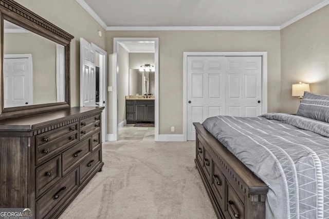 carpeted bedroom featuring a closet, ornamental molding, sink, and ensuite bath