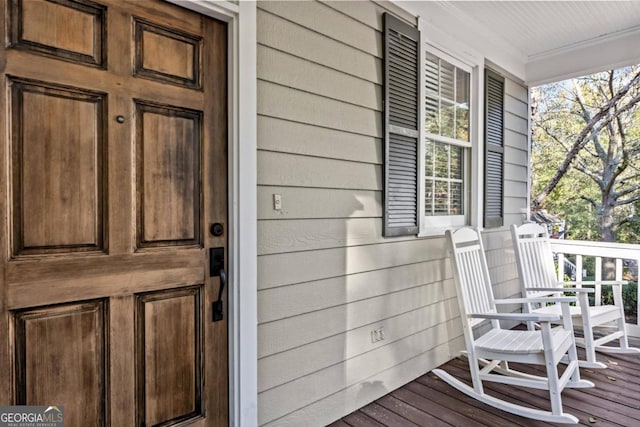 view of exterior entry with a porch