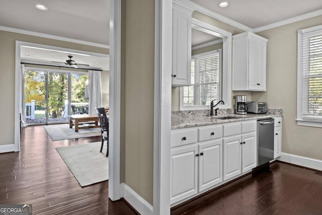 kitchen with a wealth of natural light, sink, white cabinets, and dark hardwood / wood-style floors