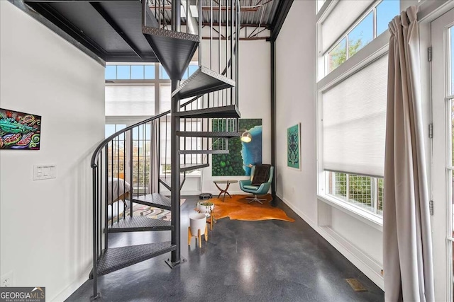 stairs featuring a high ceiling